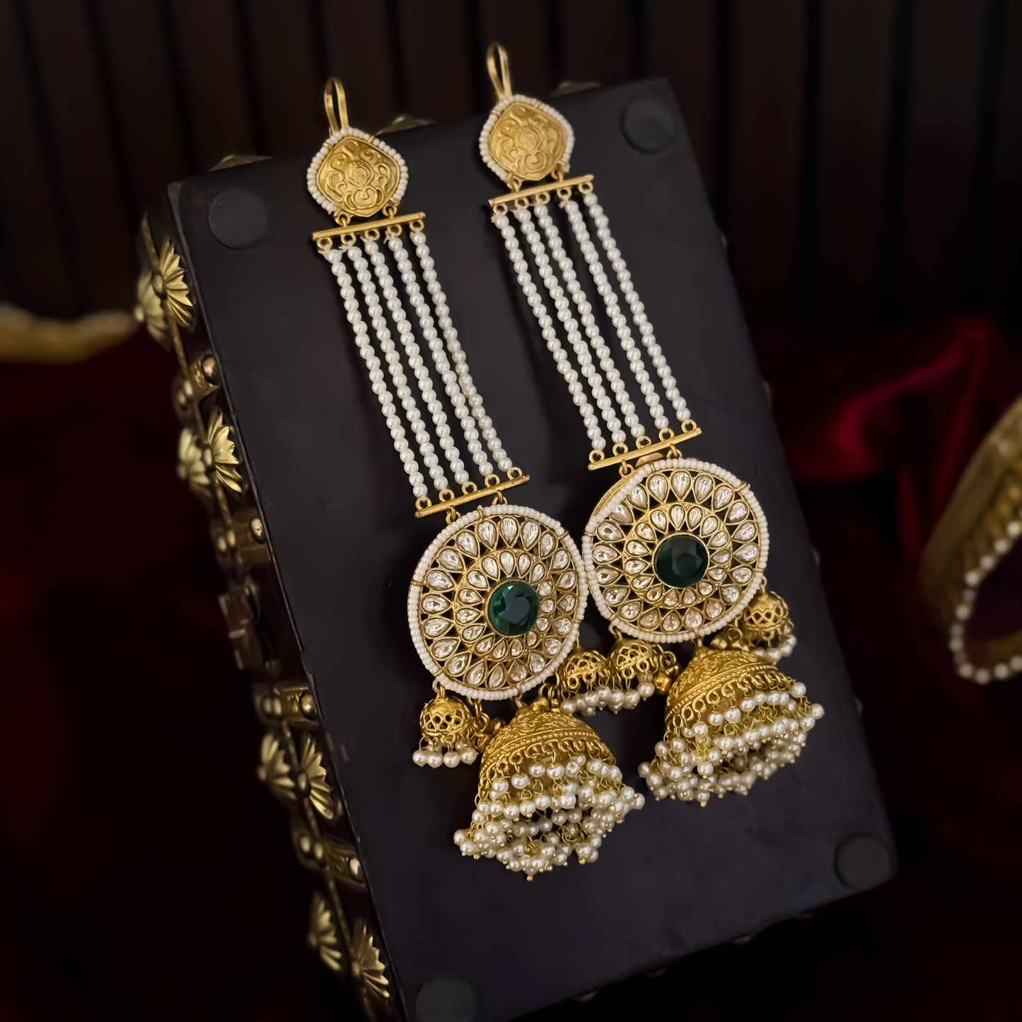 Raanisa premium antique gold kashmiri jhumka earrings featuring five strand pearl ear chains large circular kundan wheel medallion with green center stone and cluster pearl drops