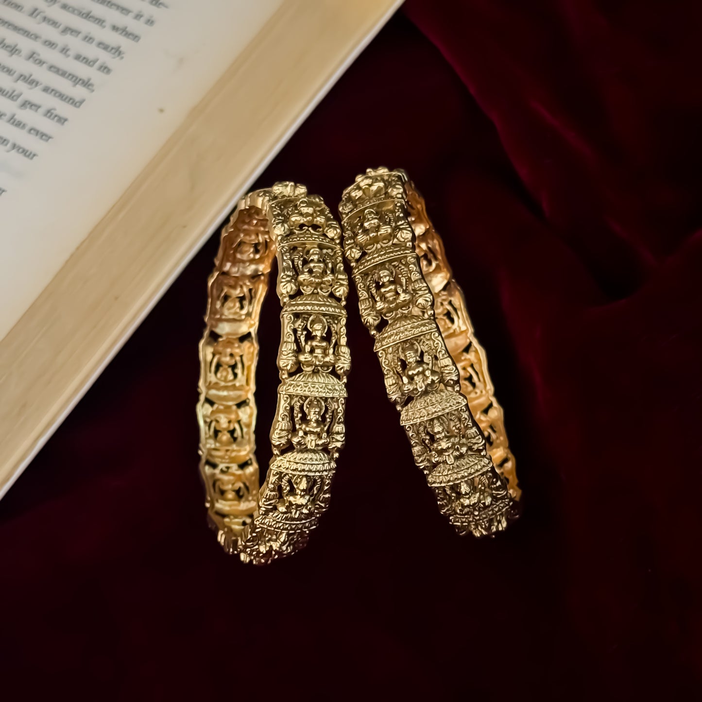 Tarakshi premium antique gold temple bangles featuring continuous rows of sculpted goddess lakshmi motifs in micro arches
