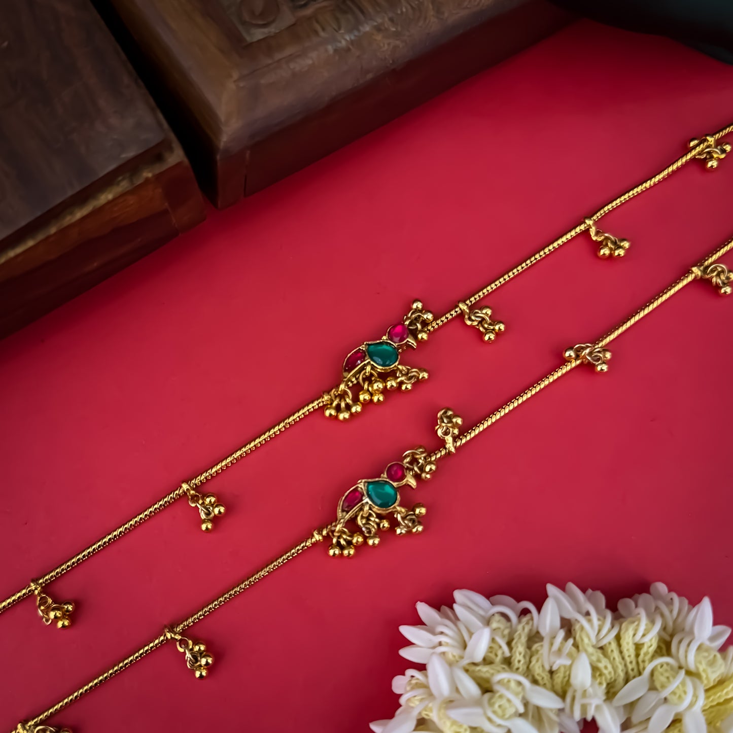 Floral Temple premium antique gold anklet pair featuring flexible double strand woven chain bands linked circular ruby pink and green kemp stone rosettes and cascading gold ghungroo fringes