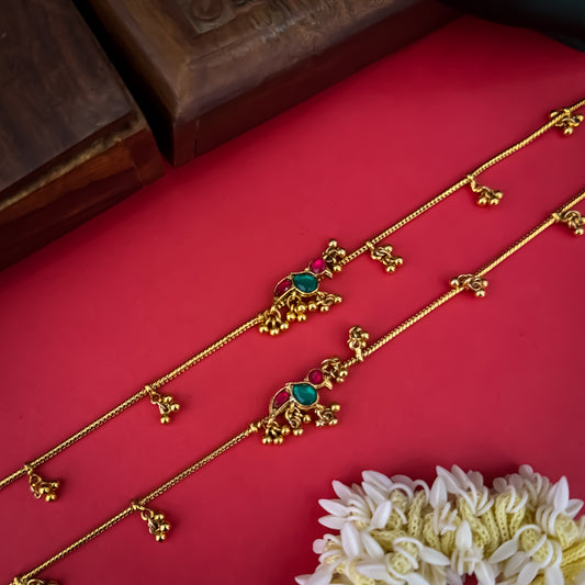 Floral Temple premium antique gold anklet pair featuring flexible double strand woven chain bands linked circular ruby pink and green kemp stone rosettes and cascading gold ghungroo fringes