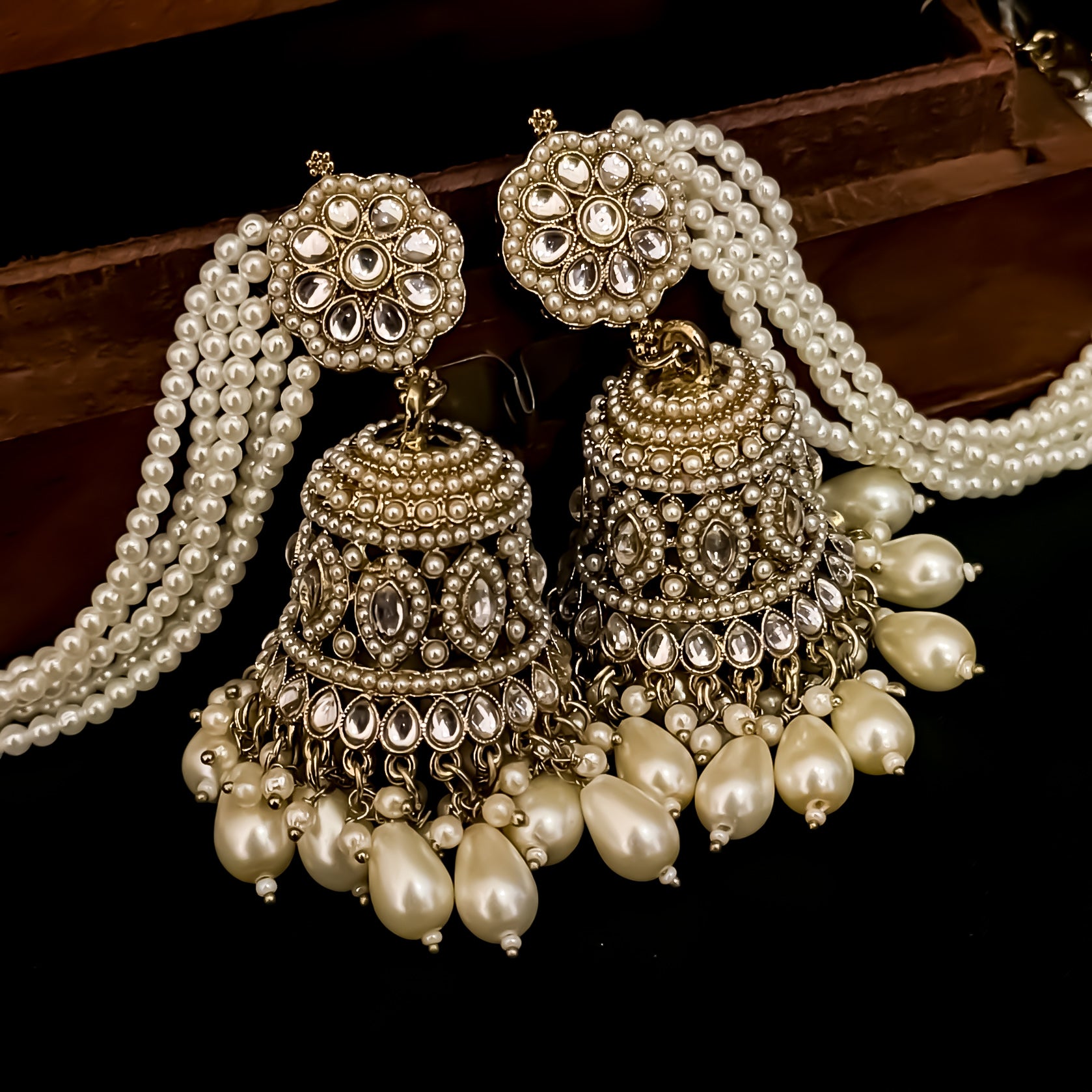 Traditional antique gold reverse american diamond bridal earrings featuring monochromatic white pearls with cascading teardrop drops and pearl sahara support chains