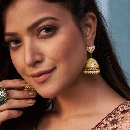 Meenakari lotus jhumka earrings featuring pastel lemon green hand painted enamel domes with pink lotus flowers and hanging white pearls