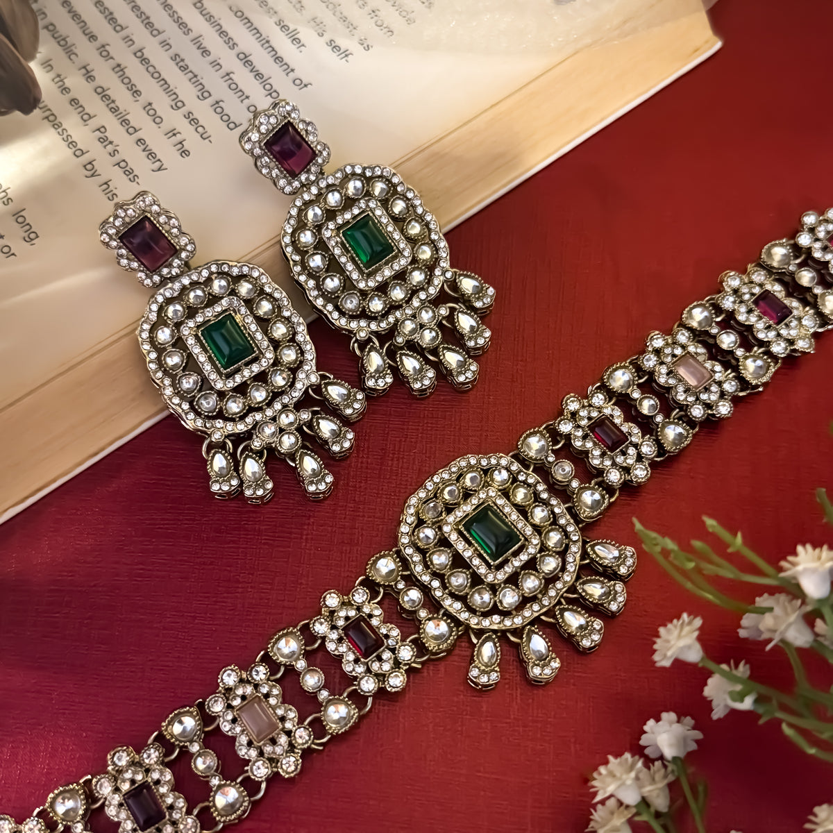Ruhanika premium antique gold kundan broad choker necklace set featuring a segmented panel collar tracking of rectangular pastel pink quartz stones a large central rounded rectangular medallion matching tiered dropdown earrings