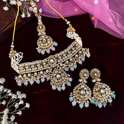 Rosen premium antique gold kundan broad choker necklace set featuring linked tracks of clear dabi stones a dense cascading fringe of pastel pink and mint green quartz beads with matching tiered earrings and maang tikka