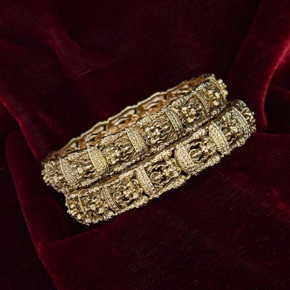 Tarakshi premium antique gold temple bangles featuring continuous rows of sculpted goddess lakshmi motifs in micro arches
