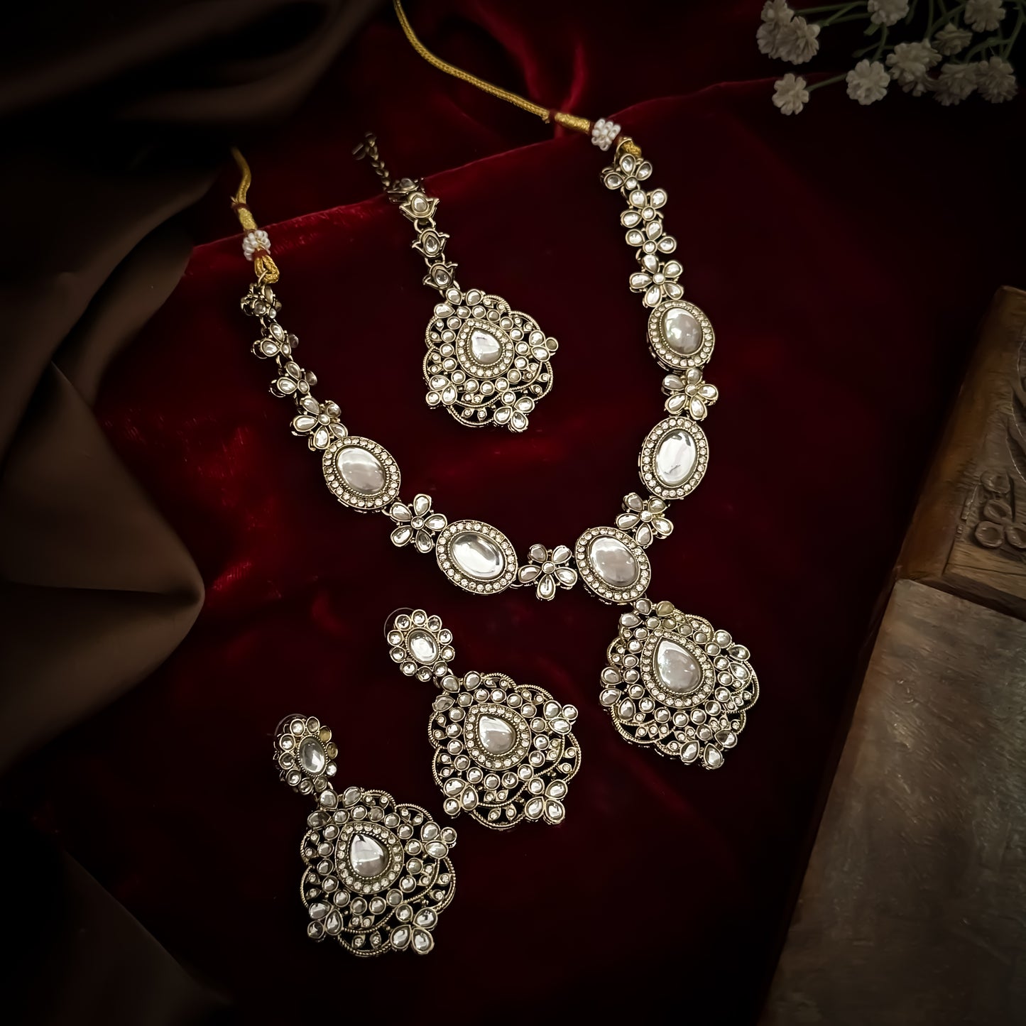 Golden Vanshika premium zircon kundan necklace set featuring oval stone links floral clusters large shield pendant matching earrings and maang tikka