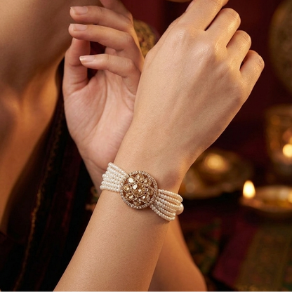 Rushali adjustable antique gold bracelet featuring a round floral blooming kundan medallion and a six strand micro pearl band