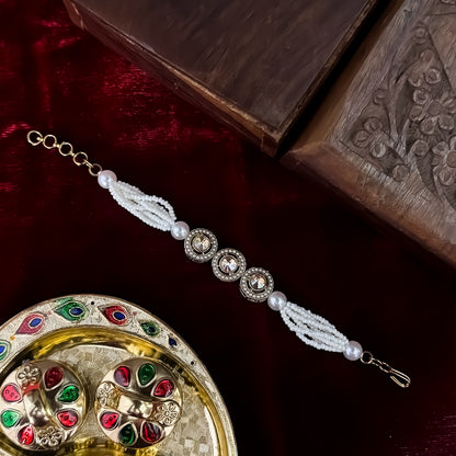 Akanksha adjustable antique gold bracelet featuring three round jadau kundan medallions and a five strand micro pearl band