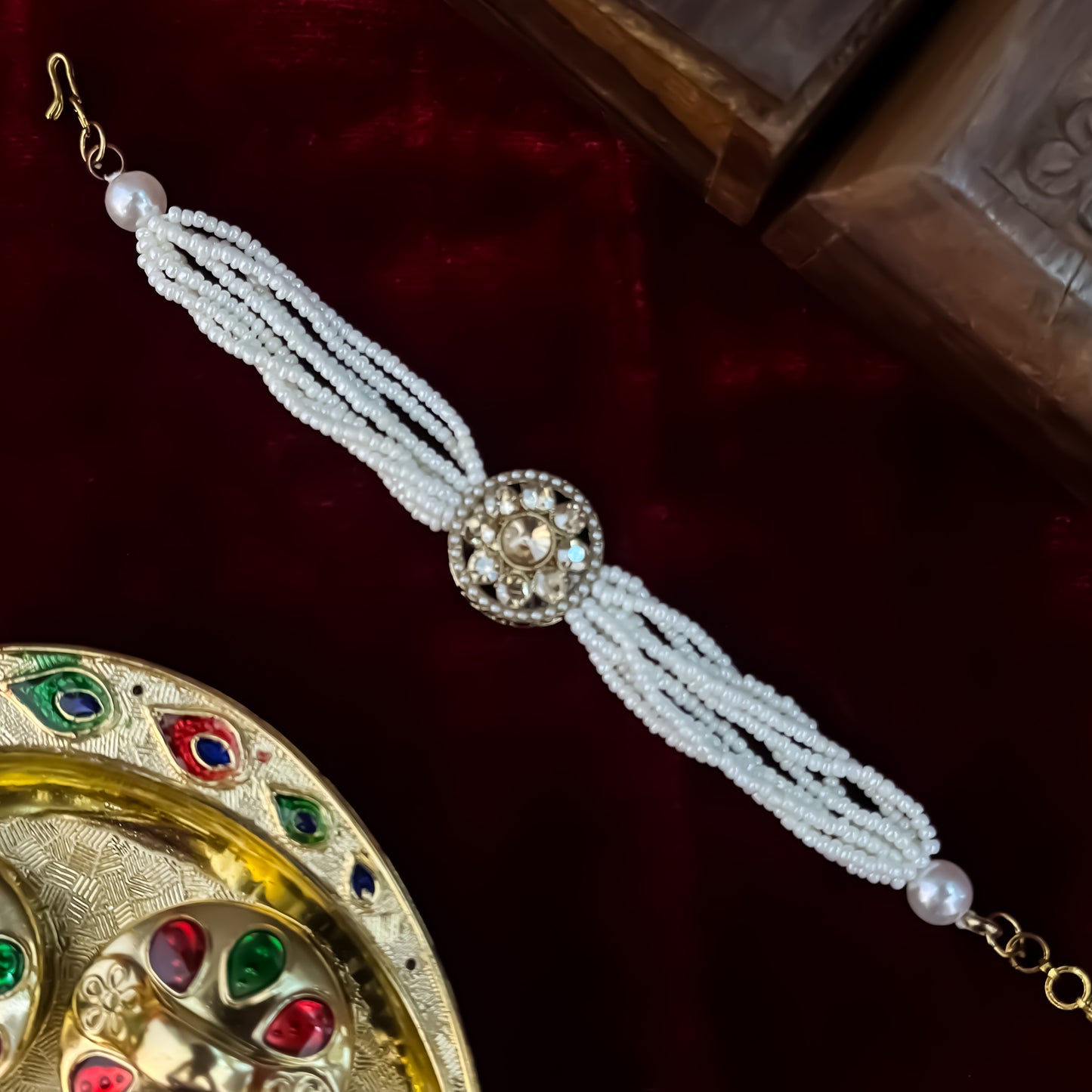 Rushali adjustable antique gold bracelet featuring a round floral blooming kundan medallion and a six strand micro pearl band