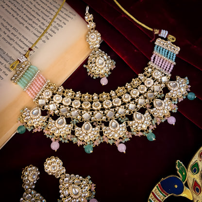 Maisha premium antique gold kundan broad choker necklace set featuring linked tracks of clear dabi stones a dense cascading fringe of pastel pink and mint green quartz beads with matching tiered earrings and maang tikka