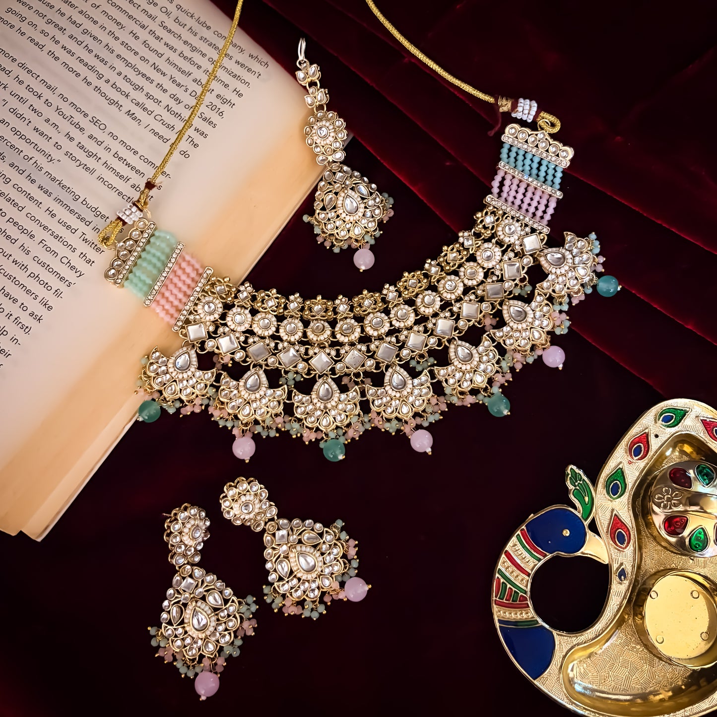Maisha premium antique gold kundan broad choker necklace set featuring linked tracks of clear dabi stones a dense cascading fringe of pastel pink and mint green quartz beads with matching tiered earrings and maang tikka
