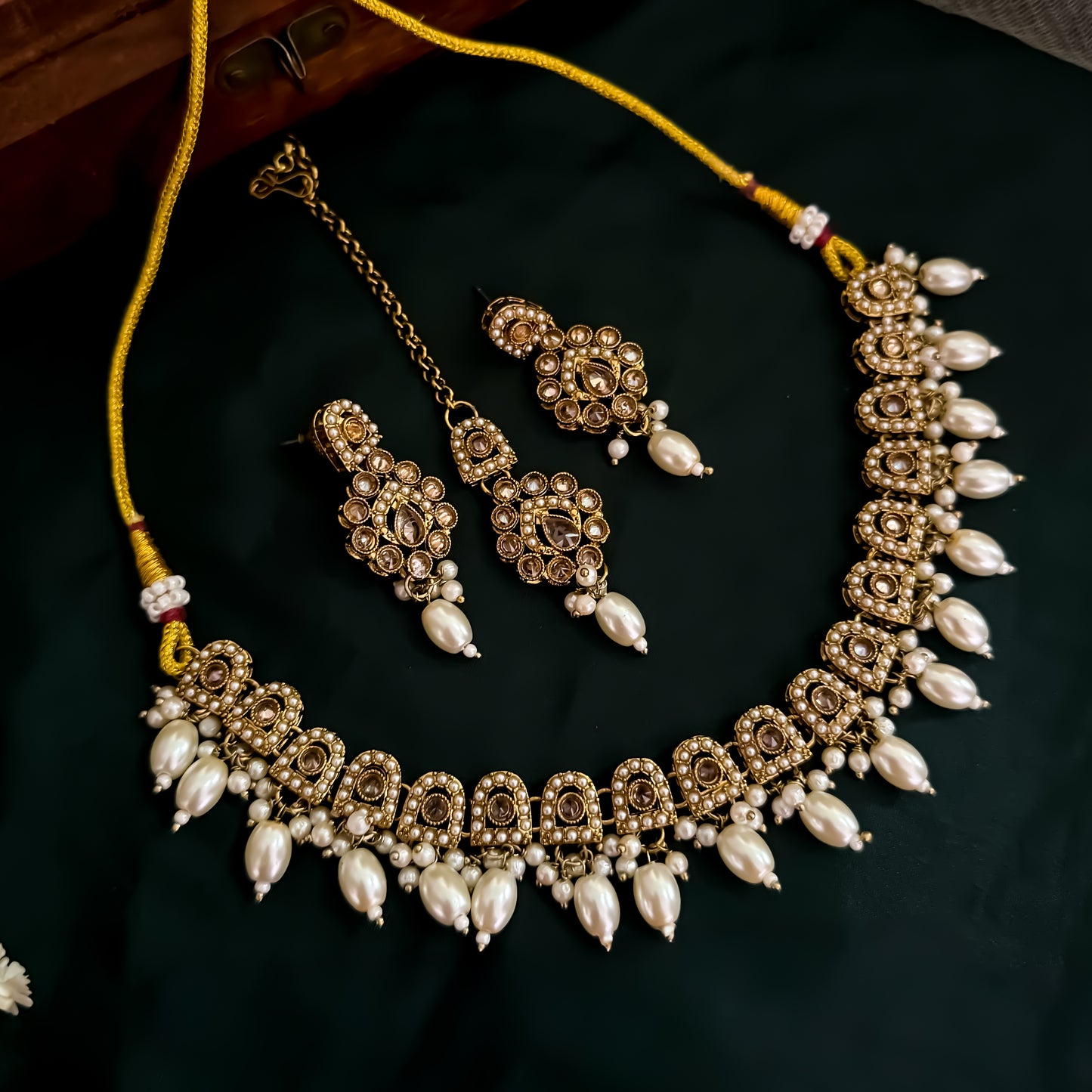 Mishka Jadau Reverse AD Sleek Golden Necklace Set with Earrings & Teeka