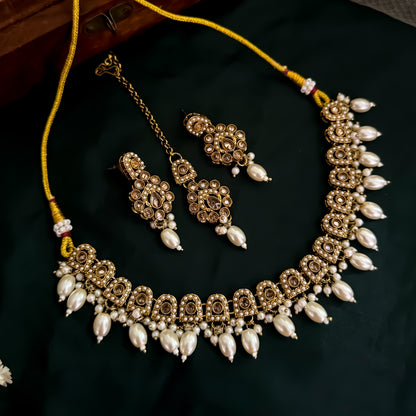 Mishka Jadau Reverse AD Sleek Golden Necklace Set with Earrings & Teeka