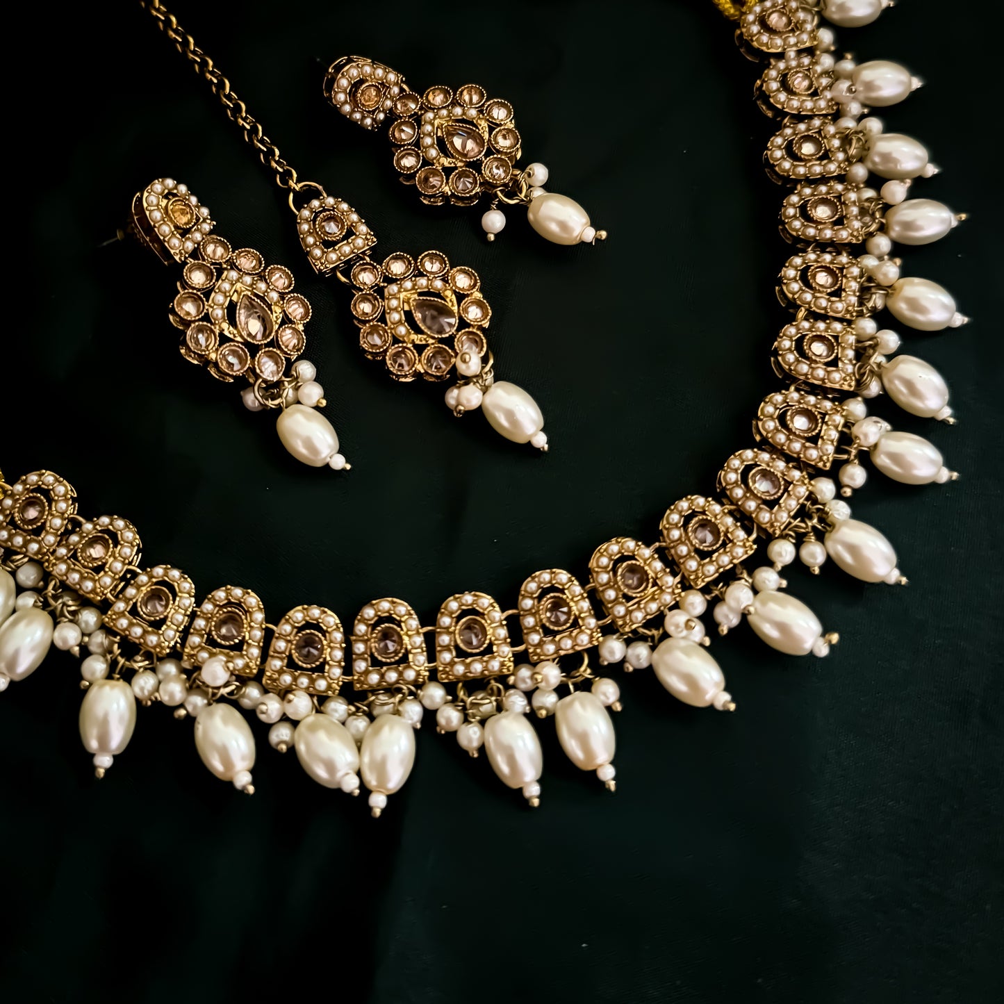 Mishka Jadau Reverse AD Sleek Golden Necklace Set with Earrings & Teeka