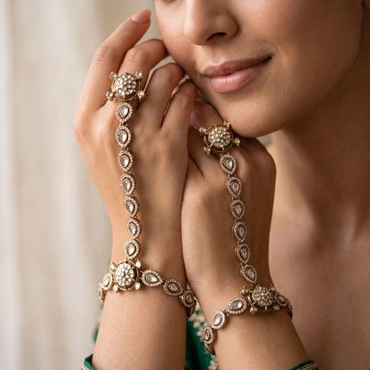 premium antique gold kundan haathphool pair featuring circular flower rosette rings linked vertical almond stone tracks and matching clear crystal wrist medallion bracelets