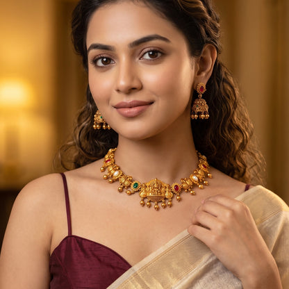 Vaidehi Navratan Temple premium antique gold hasli choker necklace set featuring a rigid torque band with embossed goddess and peacock motifs clear multicolored stones and matching drop earrings