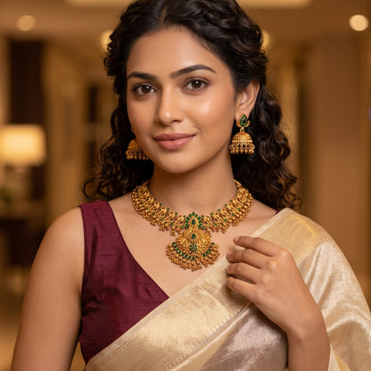 Nyra Temple premium antique gold long necklace set featuring a link strand with a large multi tiered shield pendant showing dancing peacock motifs and matching dome jhumka earrings