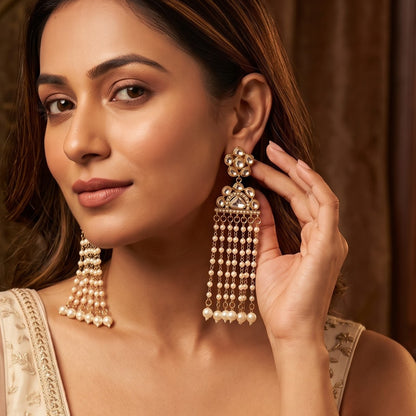 Nazar premium antique gold kundan chandelier earrings featuring a circular flower rosette top stud a crescent fan shaped medallion frame and a dense cascading tassel fringe of ten vertical pearl strands