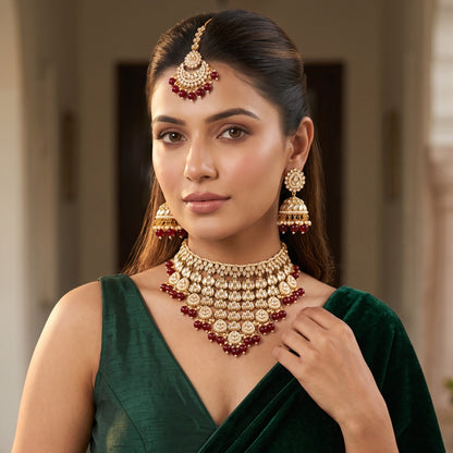 Shameena premium antique gold kundan plunging choker necklace set featuring multi tier tracks of clear dabi stones a dense cascading fringe of white pearls matching dome jhumka earrings and a crescent maang tik