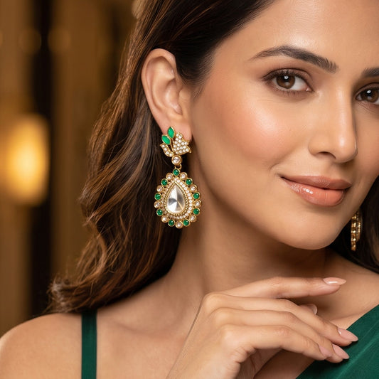 Mansi premium antique gold kundan chandelier earrings featuring pastel mint green marquise leaf studs an asymmetric pavé crystal scroll a large teardrop pendant with a central clear dabi stone and a mint green kemp halo
