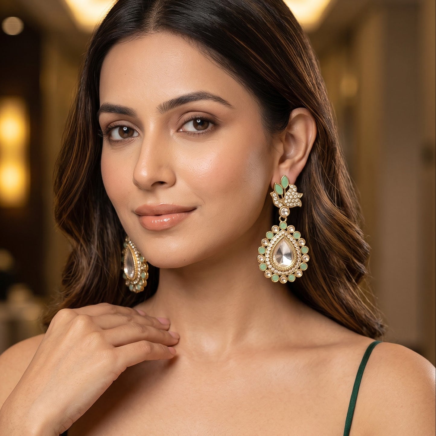 Mansi premium antique gold kundan chandelier earrings featuring pastel mint green marquise leaf studs an asymmetric pavé crystal scroll a large teardrop pendant with a central clear dabi stone and a mint green kemp halo
