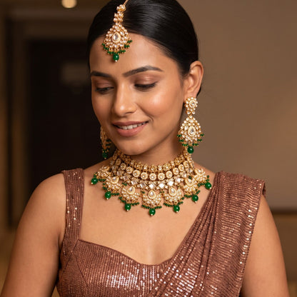 Maisha premium antique gold kundan broad choker necklace set featuring linked tracks of clear dabi stones a dense cascading fringe of pastel pink and mint green quartz beads with matching tiered earrings and maang tikka