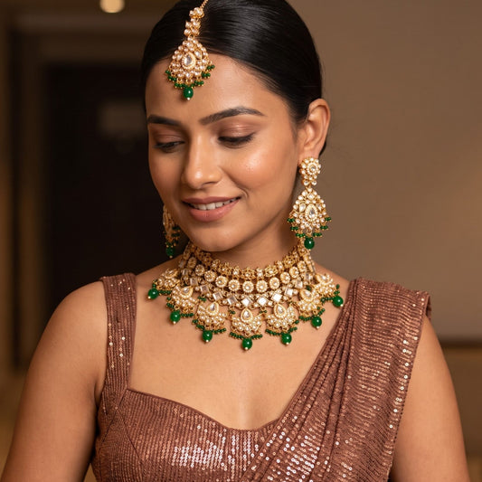 Maisha premium antique gold kundan broad choker necklace set featuring linked tracks of clear dabi stones a dense cascading fringe of pastel pink and mint green quartz beads with matching tiered earrings and maang tikka