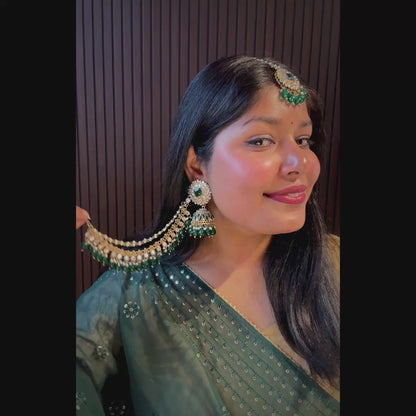 Traditional Indian antique gold bridal jewelry set featuring kundan mirror work jhumkas with green crystal drops and pearl ear extensions