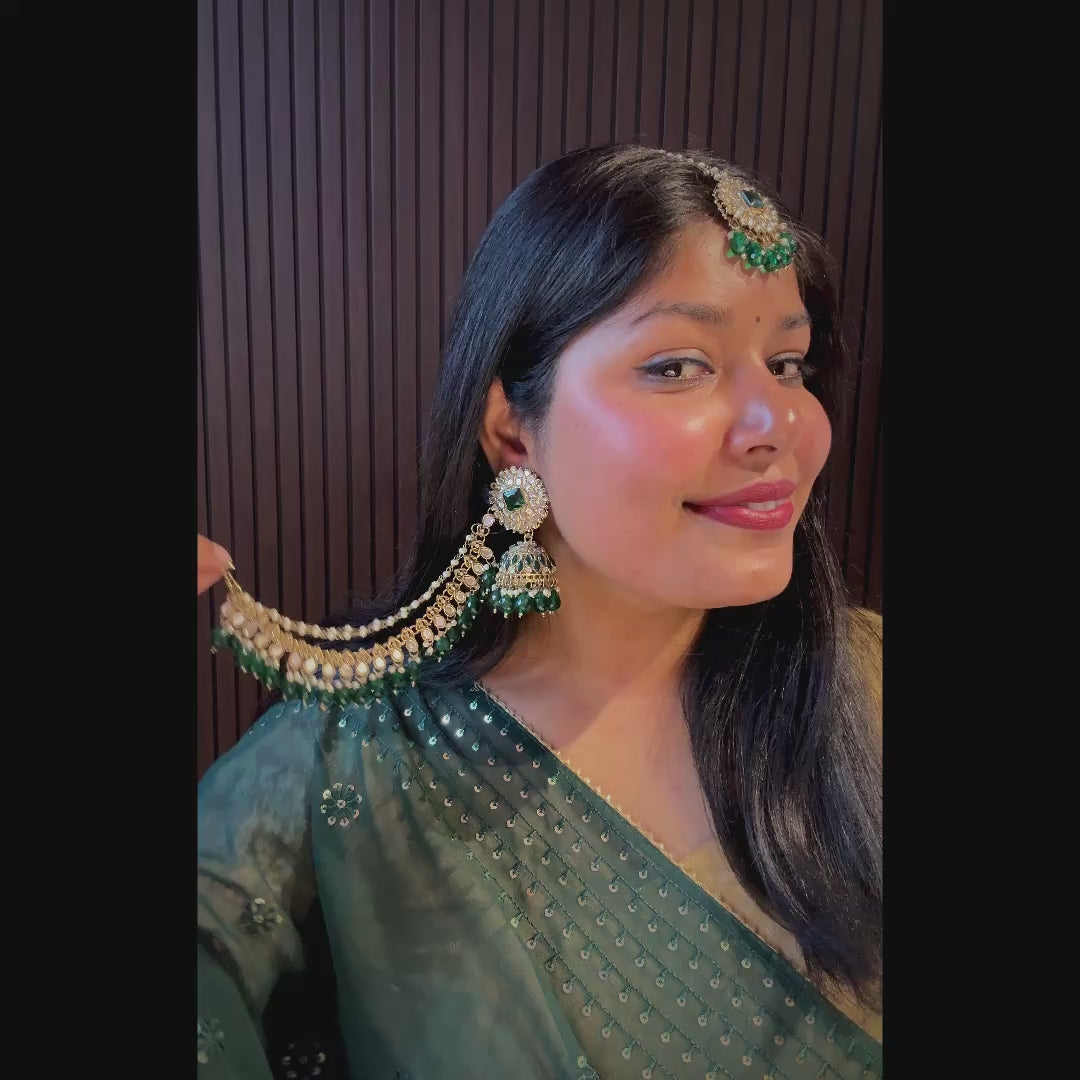 Traditional Indian antique gold bridal jewelry set featuring kundan mirror work jhumkas with green crystal drops and pearl ear extensions